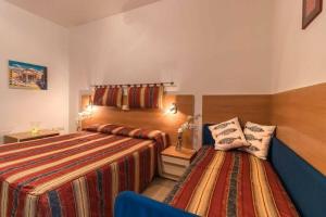 Postel nebo postele na pokoji v ubytování Hotel Corallo