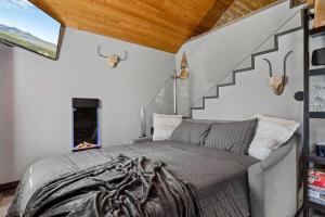 a bedroom with a large bed and a staircase at Calipe Cottage in Sugarloaf