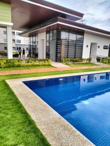 a swimming pool in front of a building at Plumera Homes in Lapu Lapu City