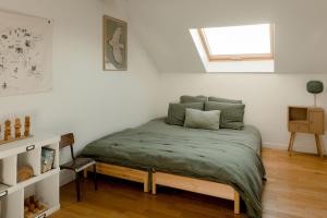 a bedroom with a bed in a room with a window at Logement entier ou à partager dans maison familiale à Rueil Malmaison, proche de Paris La Défense in Rueil-Malmaison