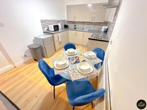 a kitchen and dining room with a table and chairs at Modern 2 Bed Apartment - FREE Parking - Contractors in Morpeth