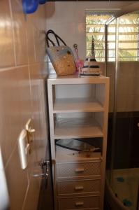 a white shelf in a bathroom with a shower at Casa Vacanze Dume in Bayahibe