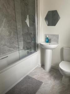 a bathroom with a shower and a toilet and a sink at Walsall New Large House with Garden in Pelsall