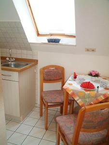 a kitchen with a table and a sink and a window at Haus Nordstrand in Büsum