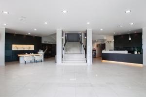 a large room with a staircase in a building at Hotel Gem in Wrocław