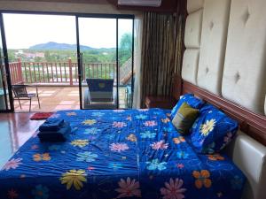 a bedroom with a blue bed with flowers on it at Phuket Private Pool and Thai Villa Style by Andaman Home in Phuket Town