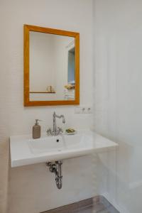 a bathroom with a white sink and a mirror at Claire de Lune in Stegersbach
