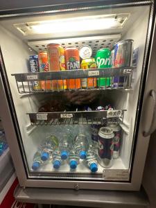 a refrigerator filled with lots of drinks and sodas at FASTHOTEL ROISSY CDG SUD - Claye Souilly in Claye-Souilly