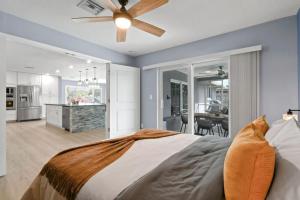 a bedroom with a bed and a ceiling fan at 5BR Wellington Equestrian Retreat in Wellington