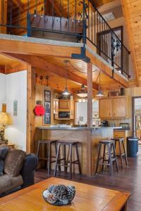 a living room and kitchen with a loft at Knoll Lake Cabin in Big Bear Lake in Big Bear Lake
