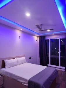 um quarto com uma cama com luzes azuis em MYKA SD ZANITA HEIGHTS em Vasco Da Gama