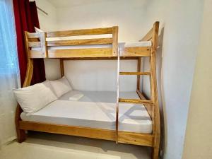 a bunk bed in a room with a ladder at Batis ni Juan Leisureland in Dipaculao