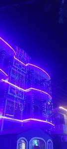 a building with purple lights on top of it at Hotel Shonarbangla in Calangute