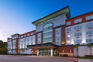 uma representação de um hotel com a frente do edifício em Four Points by Sheraton Houston West em Houston