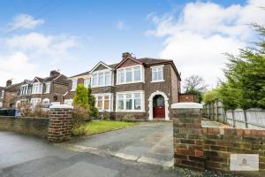 a large brick house with a red door at Modern 4-Bedroom 2-Bathroom with Off Road Parking in Great Sankey by Amazing Spaces Relocations Ltd in Great Sankey