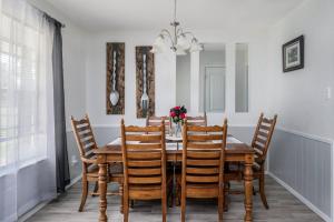 a dining room with a wooden table and chairs at Eclectic Country Home in Leander