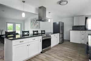 a kitchen with white cabinets and stainless steel appliances at Eclectic Country Home in Leander