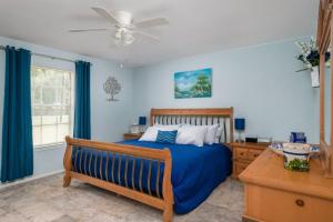 a bedroom with a bed and a ceiling fan at Eclectic Country Home in Leander +30 photos