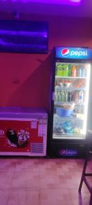 an open refrigerator with a box in front of it at Hotel Shonarbangla in Calangute
