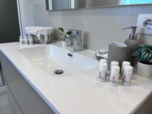 een wastafel met flessen erop bij Casa vacanze Sofy & Marty in Cattolica