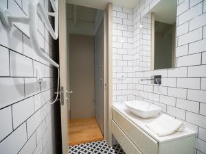 a white bathroom with a sink and a mirror at OportoCityView - Almada Luxury in Porto