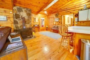 a living room with a fireplace in a log cabin at Three Bears Cabin btwn Mt Snow and Stratton Mtn! in Wardsboro