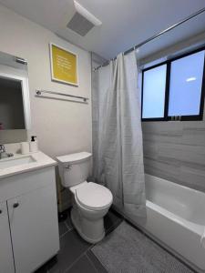 a bathroom with a toilet and a sink and a shower at Prime Location Apt on Calle Ocho in Little Havana in Miami