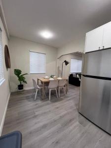 a kitchen and dining room with a table and a refrigerator at Prime Location Apt on Calle Ocho in Little Havana in Miami