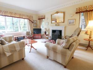a living room with two chairs and a fireplace at The Lodge in Grantham