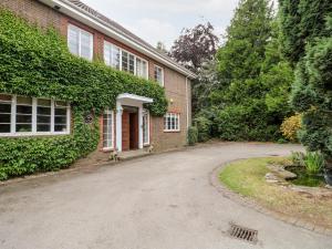 a brick house with a driveway in front of it at The Lodge in Grantham