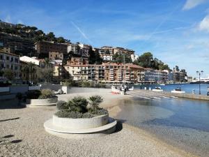a view of a beach with buildings and the water at SWEET LIANA un tuffo nel cuore del paese in Porto Santo Stefano