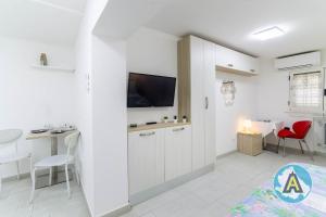 a bedroom with a bed and a desk and a tv at Casa Arcobaleno 57p in Pescara
