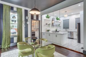 a kitchen with a glass table and green chairs at Stylish Home in Springfield Historic District! in Jacksonville
