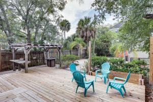 three chairs and a table on a wooden deck at Stylish Home in Springfield Historic District! in Jacksonville
