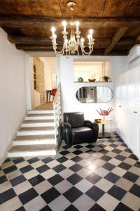 a living room with a chandelier and a checkered floor at 25 Lazzaro Bonamigo in Bassano del Grappa