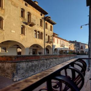 a building with a fence in front of a street at 25 Lazzaro Bonamigo in Bassano del Grappa