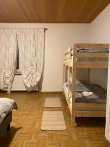 a bedroom with two bunk beds and a window at Anna in Hinterberg