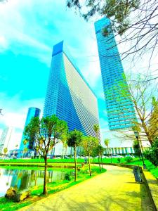 a tall building in a city with trees in front at ORBI SITY BATUMI in Batumi