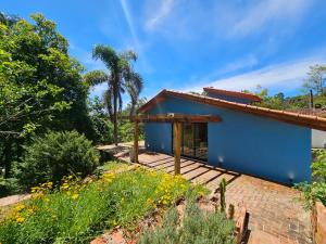 een blauw huis met een bakstenen patio bij Cabana do Rancho Roque Reis - Wine and Nature in Piedade