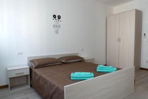 a bedroom with a large bed with two towels on it at BnB Martin in Jesolo