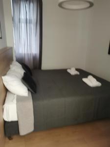 um quarto com uma cama preta e almofadas brancas em BG Exclusive Apartment em Belgrado