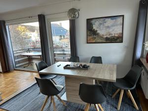 a dining room with a table and chairs and a window at Fewo Zentral in Willingen