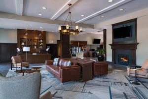 a living room with a couch and a fireplace at Four Points by Sheraton Houston West in Houston