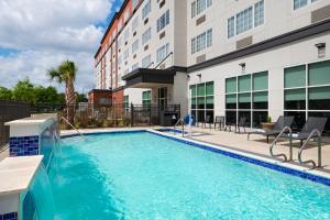 a swimming pool in front of a building at Four Points by Sheraton Houston West in Houston