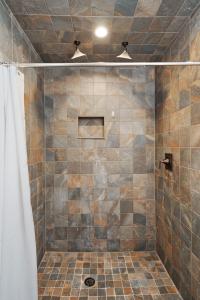 a bathroom with a shower with a tiled shower at Emerald Cabin W/Hot tub, Firepit, Lake, Skiing in Basye