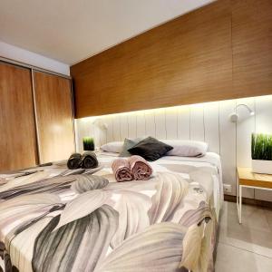 a bedroom with two beds with towels on them at Luxury Apartment Playa del Inglés in San Bartolomé de Tirajana