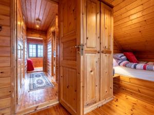 a room with two beds in a wooden cabin at 3 Bed in Clovelly 00368 in Clovelly