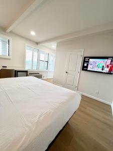 a bedroom with a large bed and a flat screen tv at Francisco Bay Inn in San Francisco