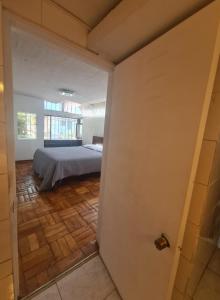 a view of a bedroom with a bed in a room at Las condes, Amplia habitación con baño privado in Santiago