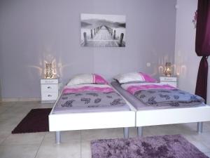 sypialnia z 2 łóżkami i 2 szafkami nocnymi w obiekcie Ferienwohnung "Sweet Home" w mieście Eupen
